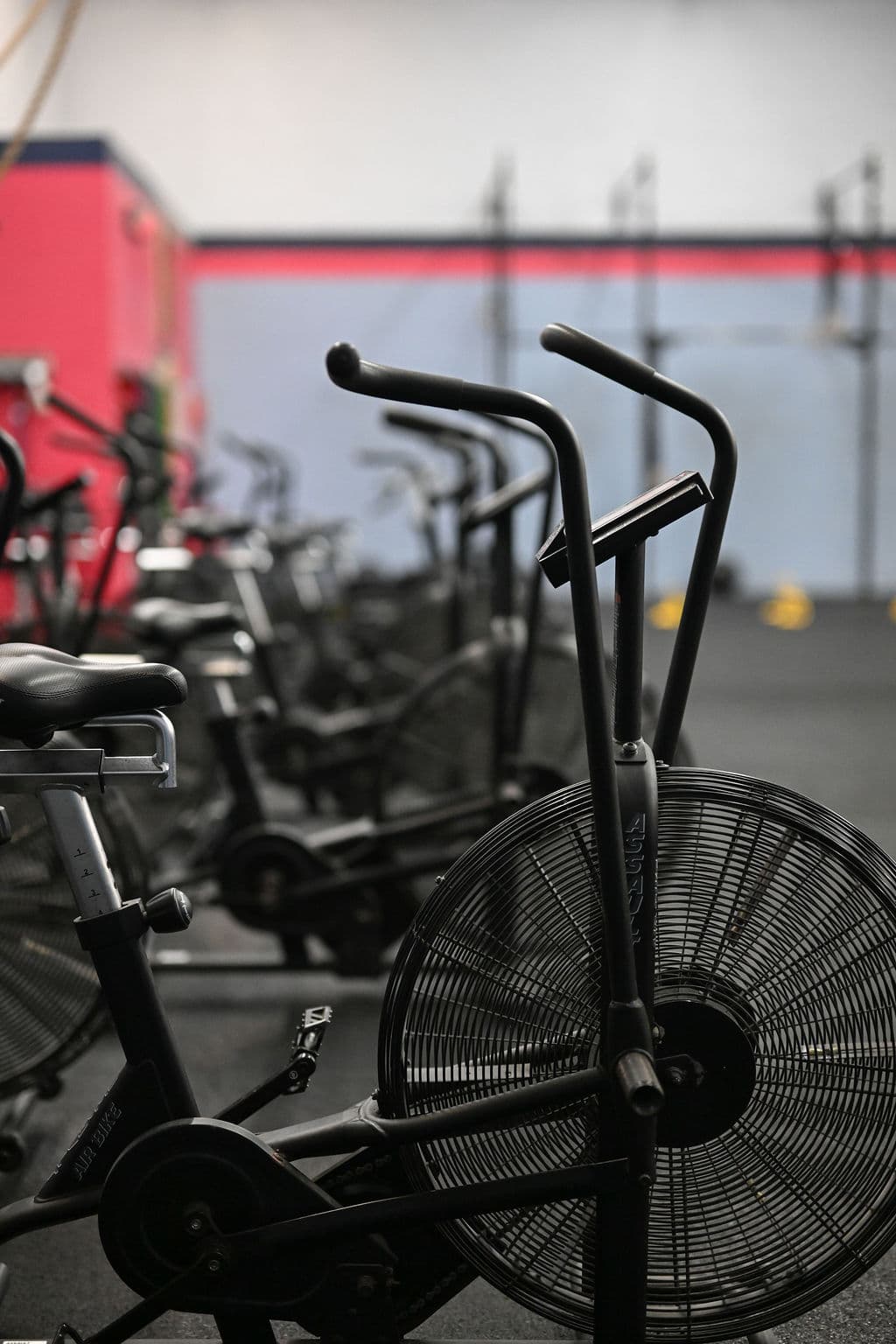 Open gym equipment including assault bikes and rigs at Monument Fitness Charlestown, MA